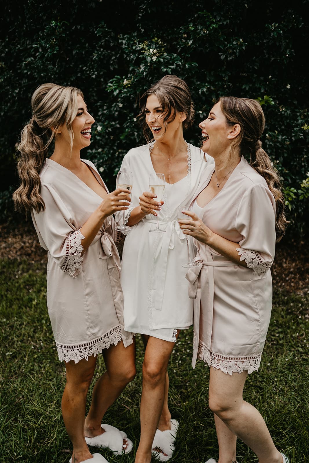 Bride and bridesmaids drinking champagne