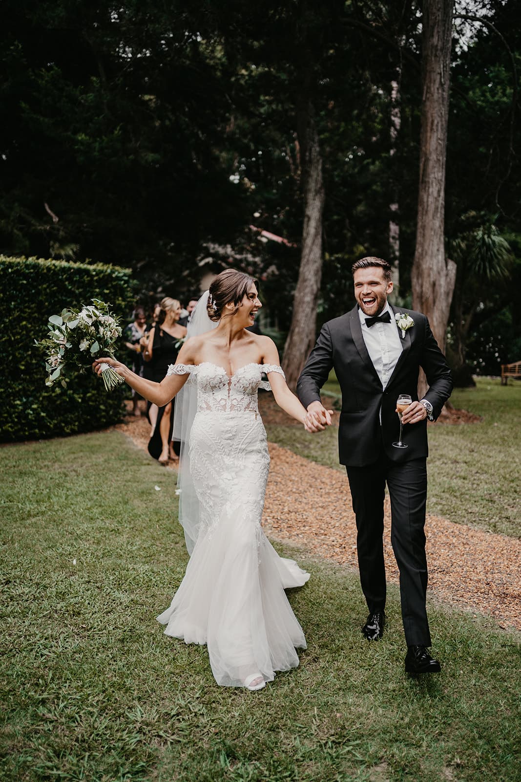 Bride and groom laughing and walking