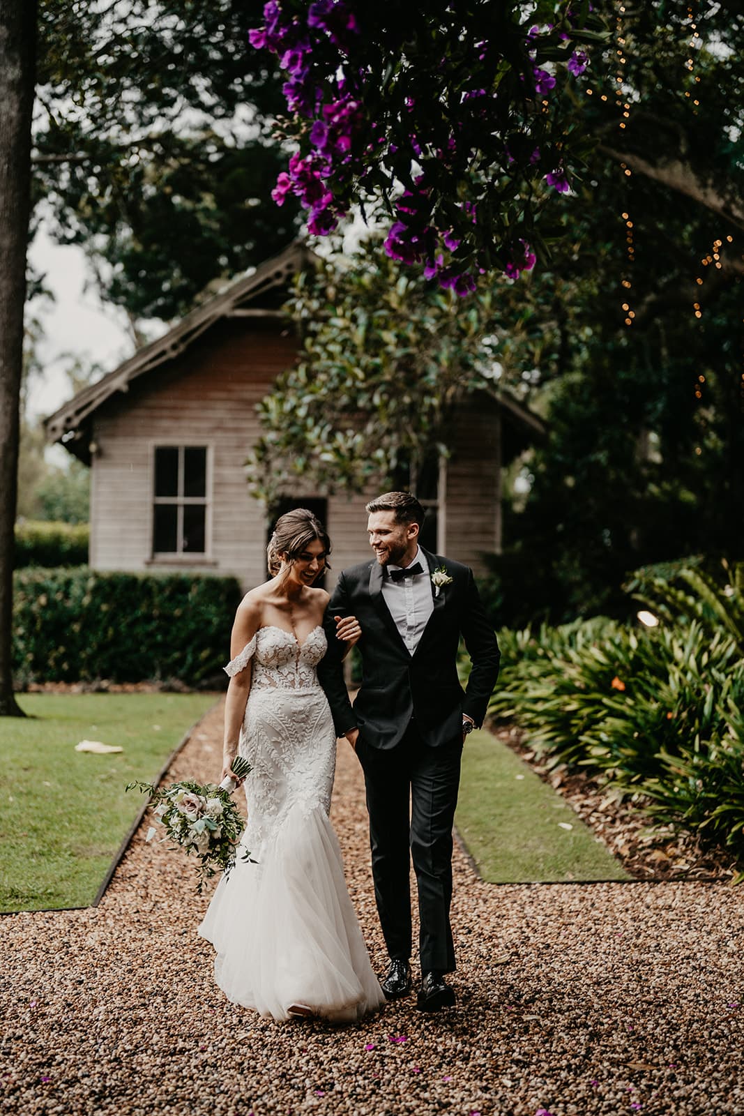 Bride and groom walking along arm in arm