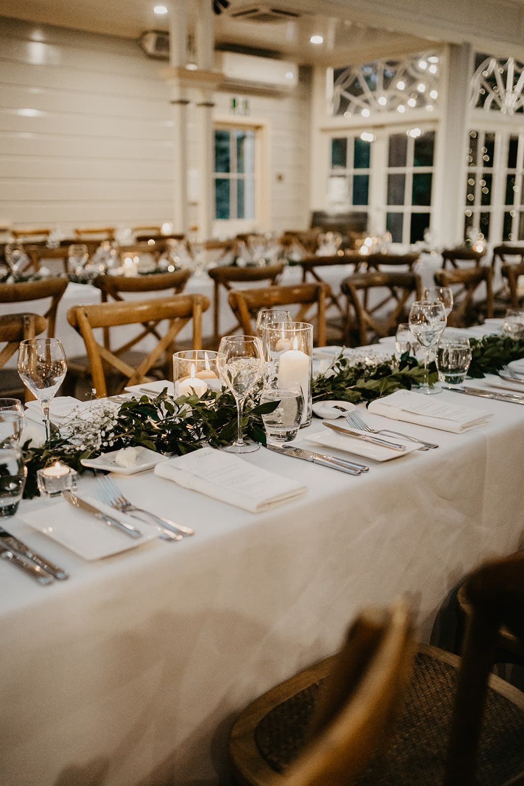 Wedding reception with greenery garlands and candles