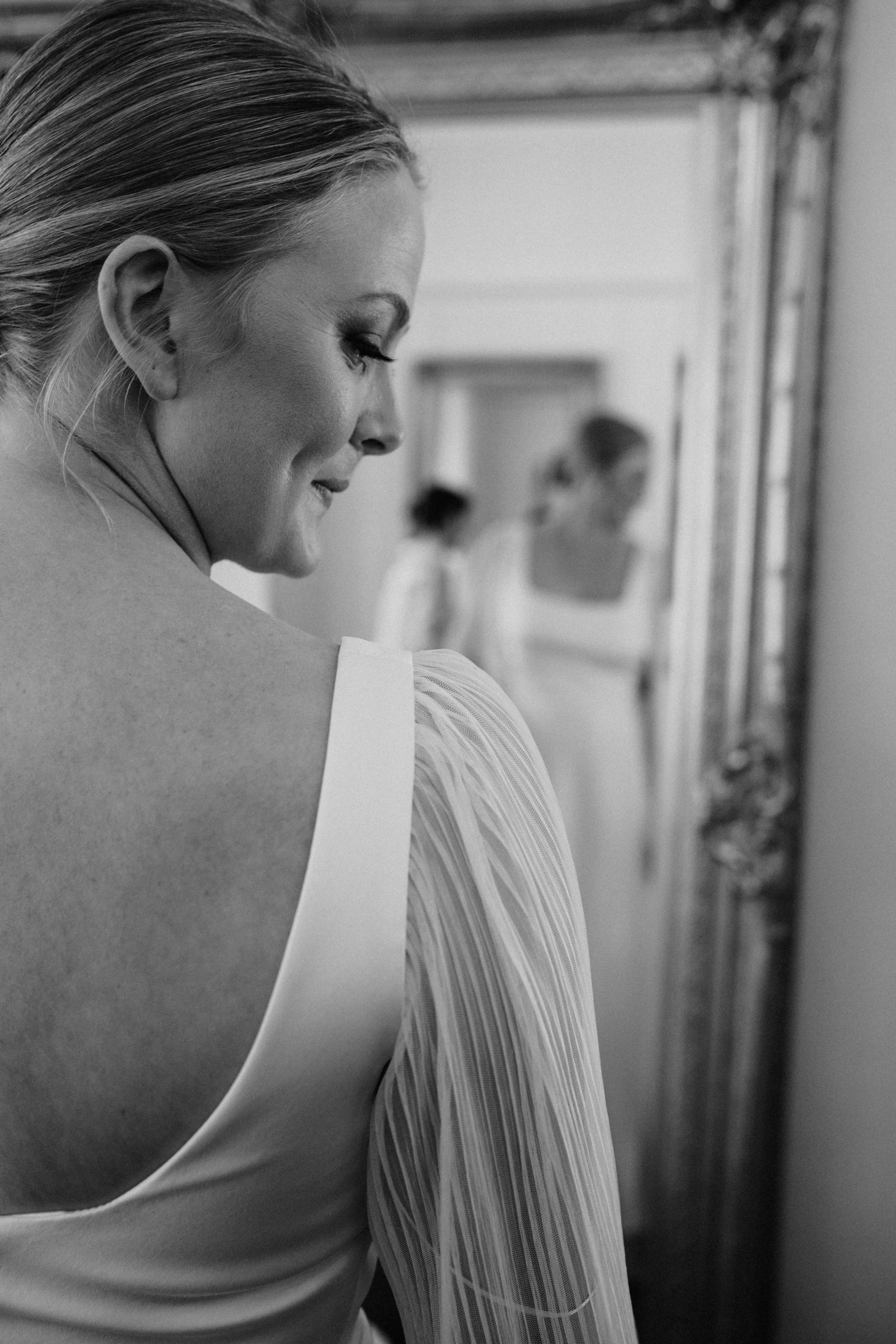 Bride looking in mirror