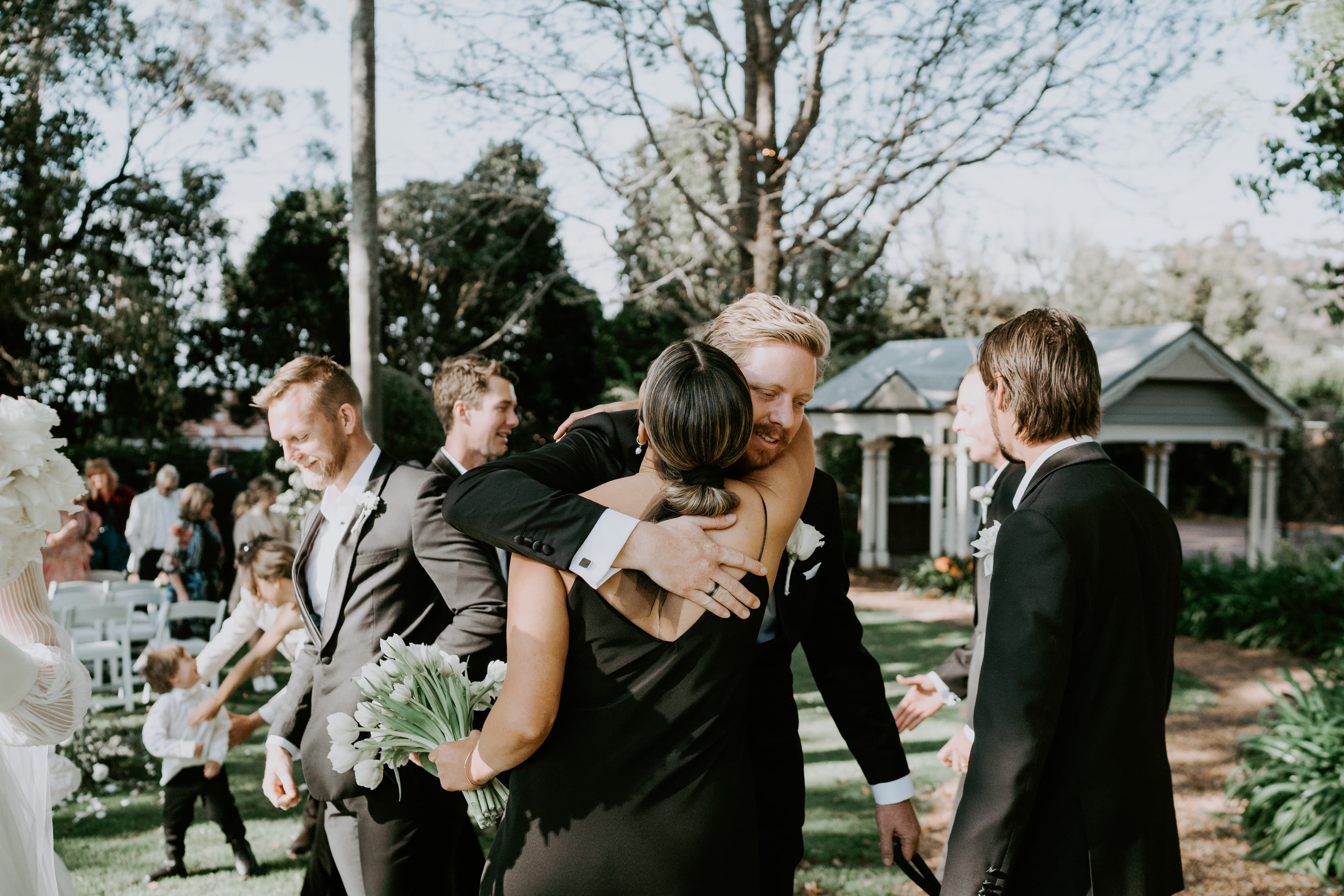 Groom hugging wedding guest