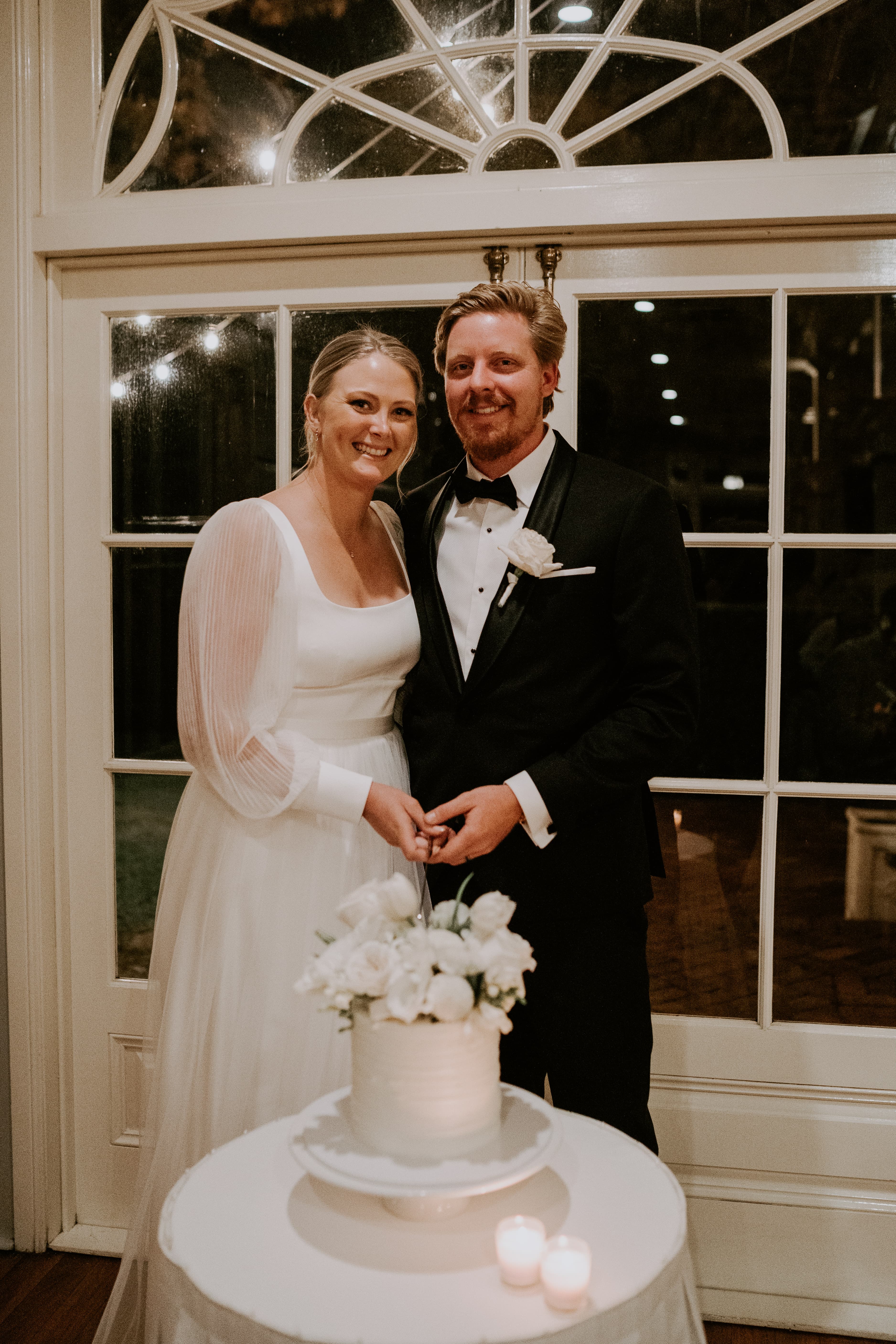 Bride and groom cutting wedding cake