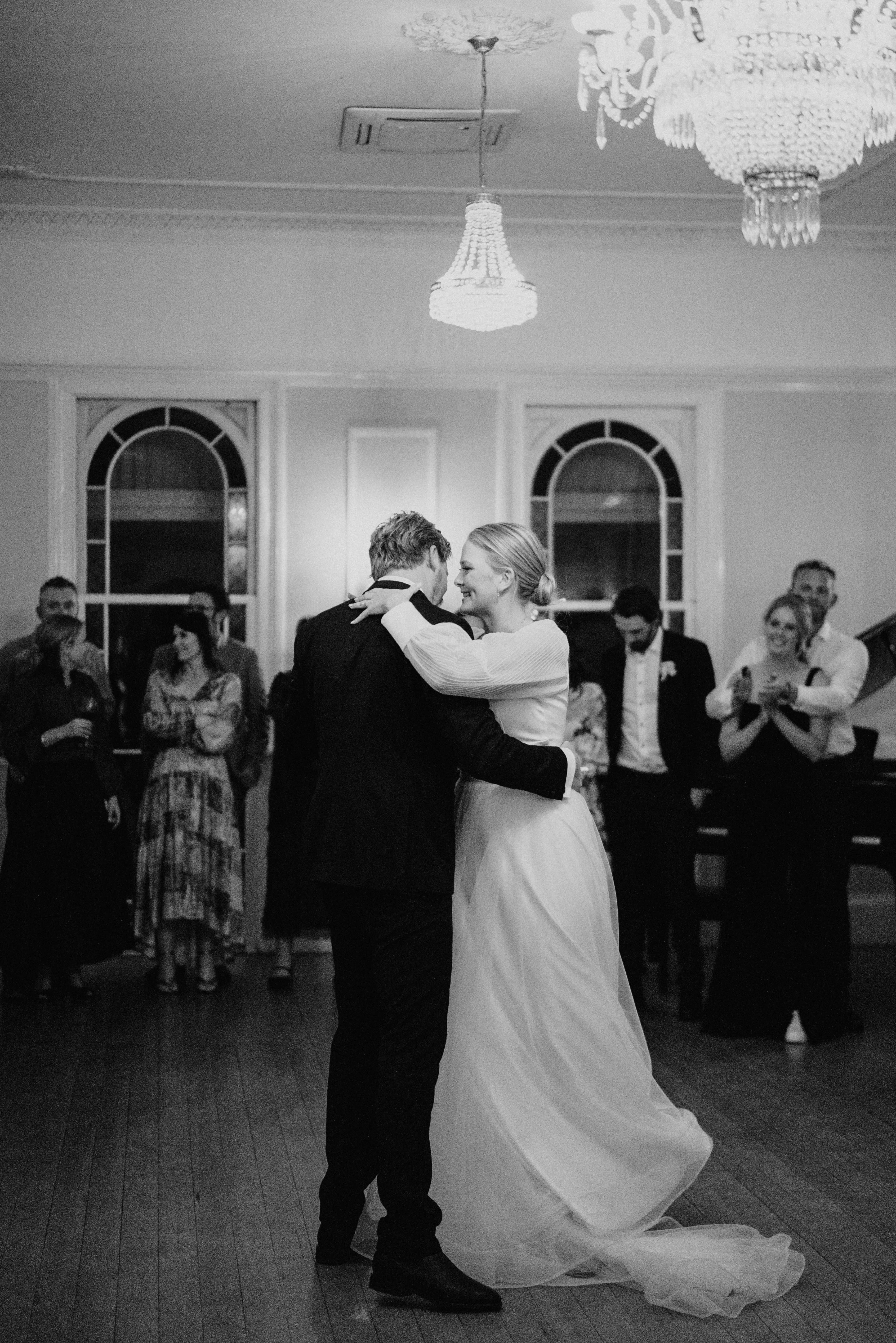 Bride and groom dancing in ballroom