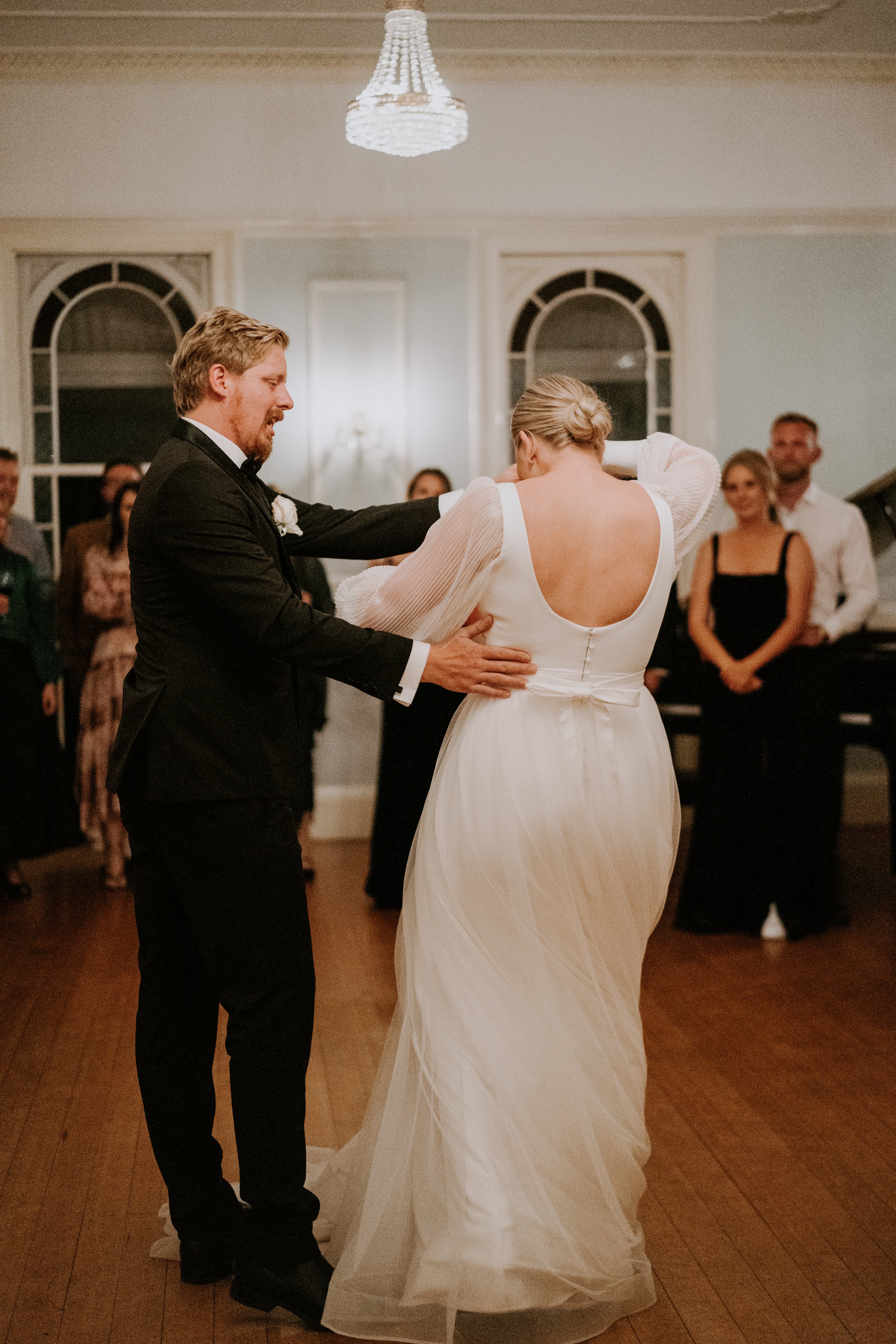 Bride and groom dancing in ballroom