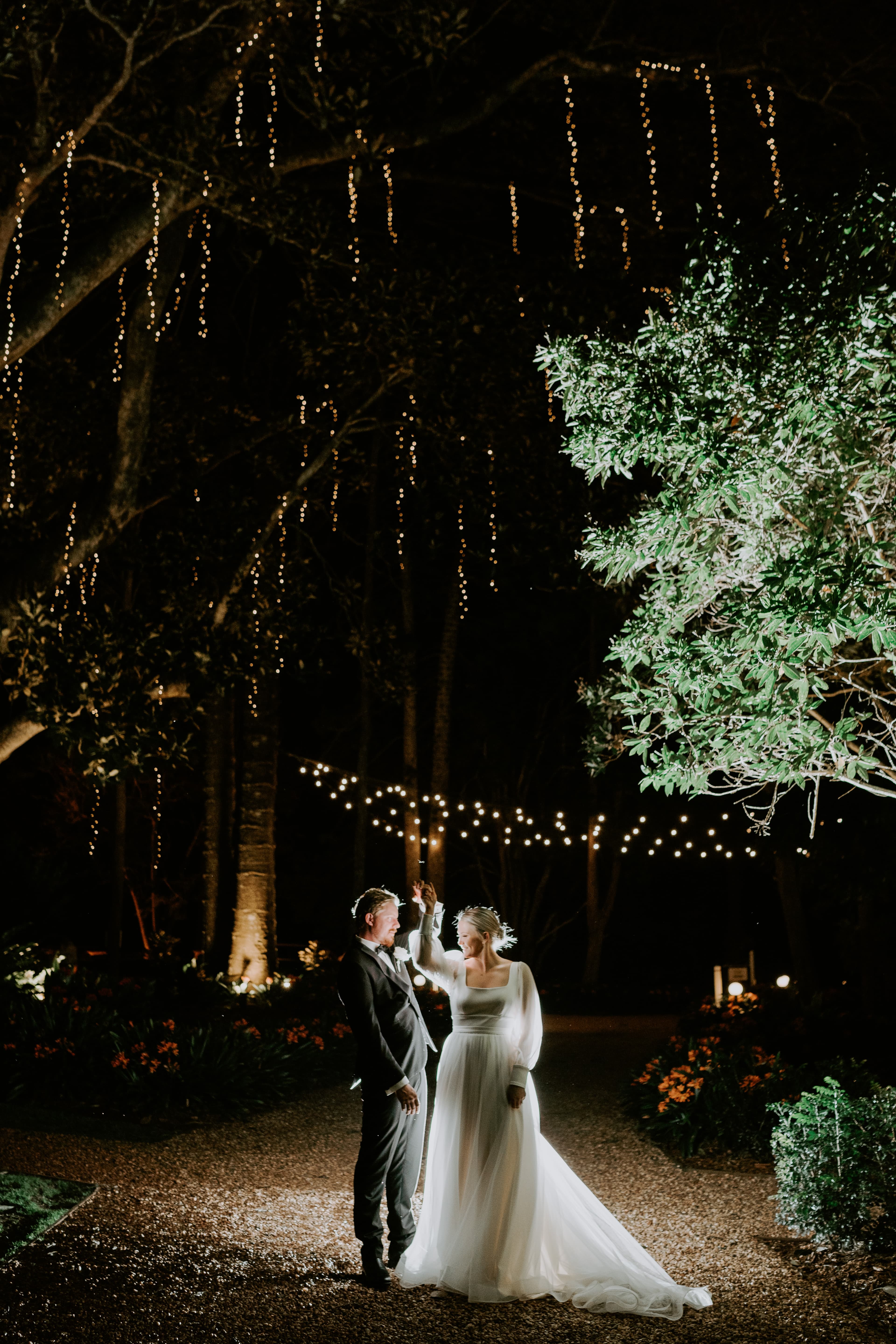 Bride and groom dancing outside