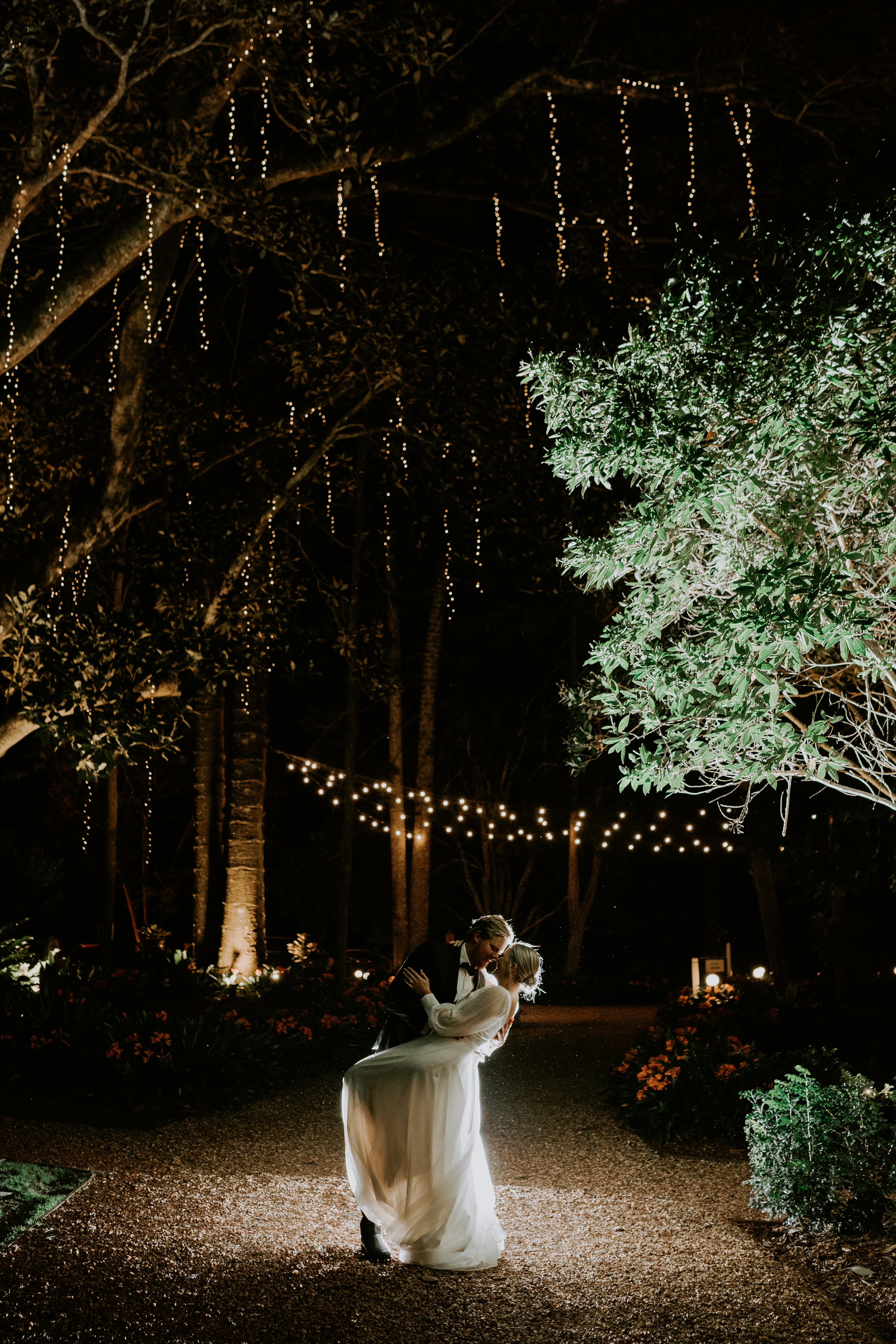 Bride and groom dancing outside