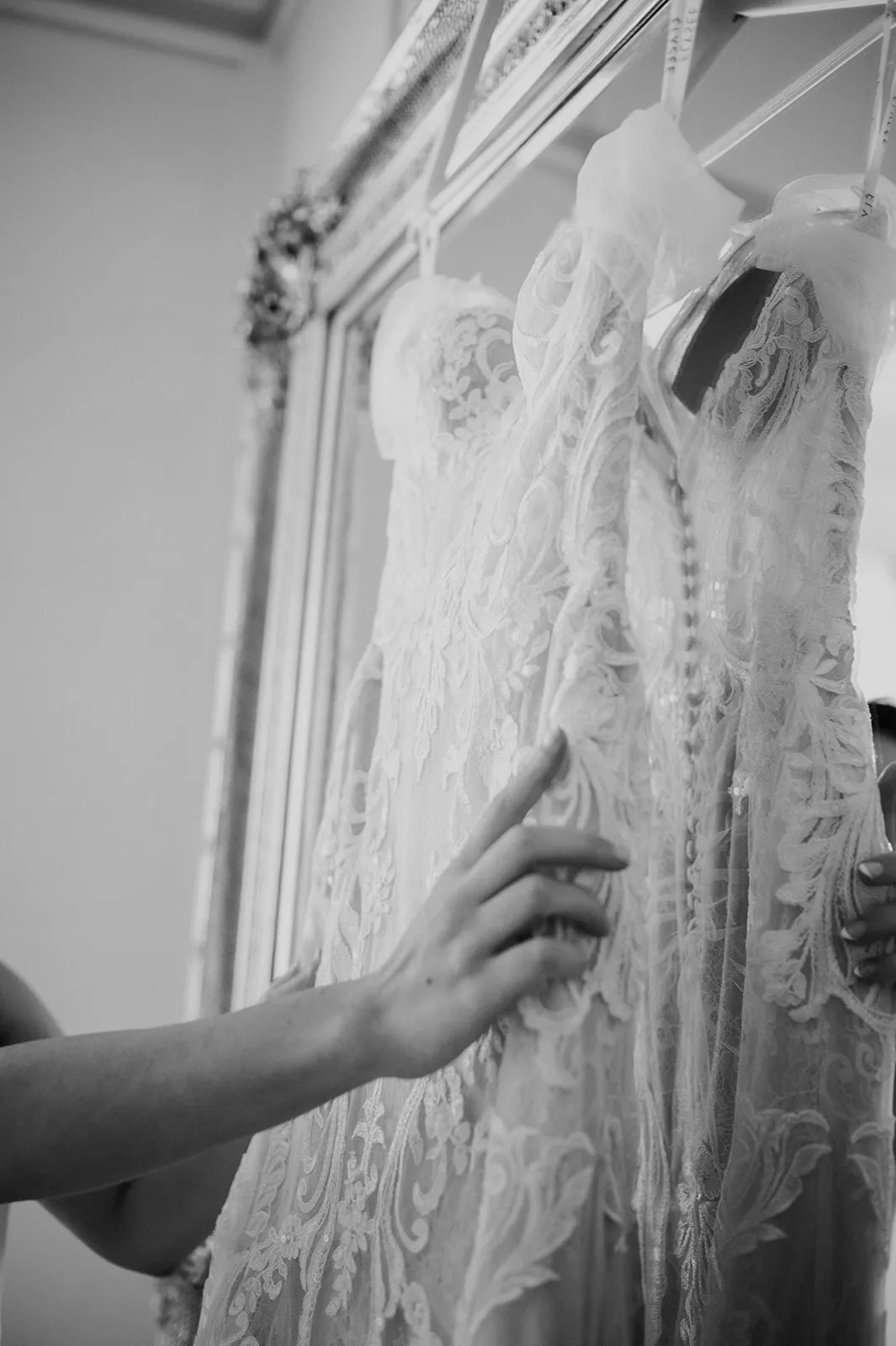 Bride touching wedding dress