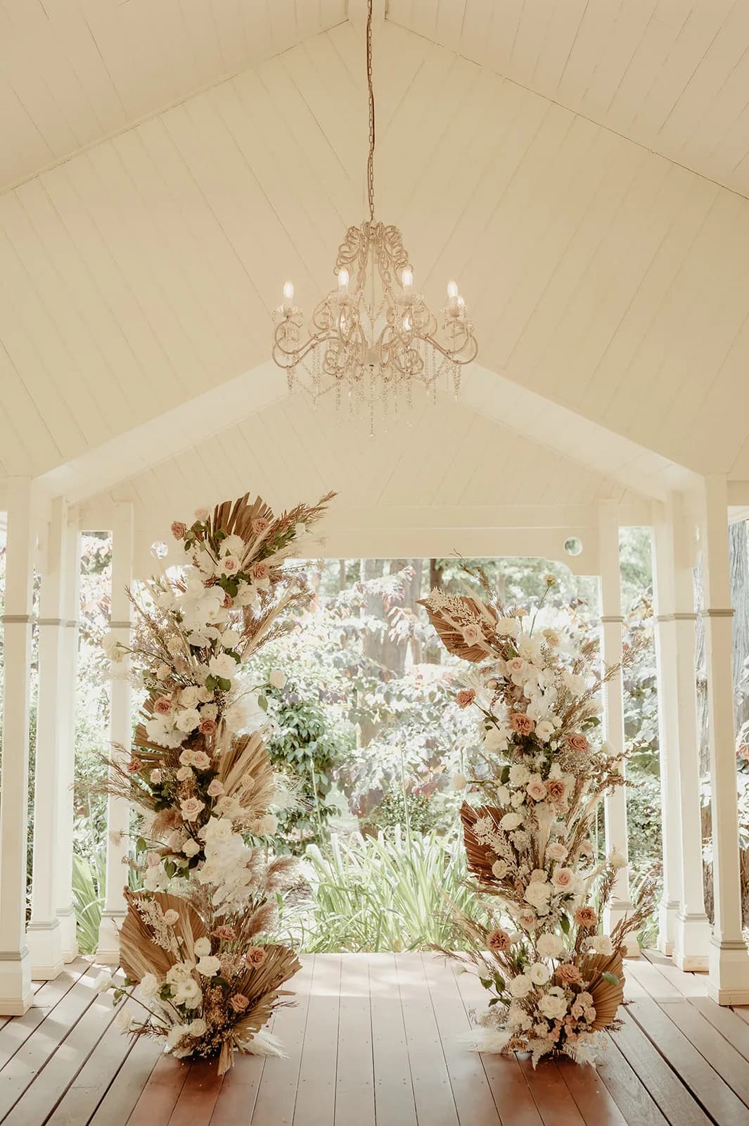 Wedding arbour with roses and dried palm fronds