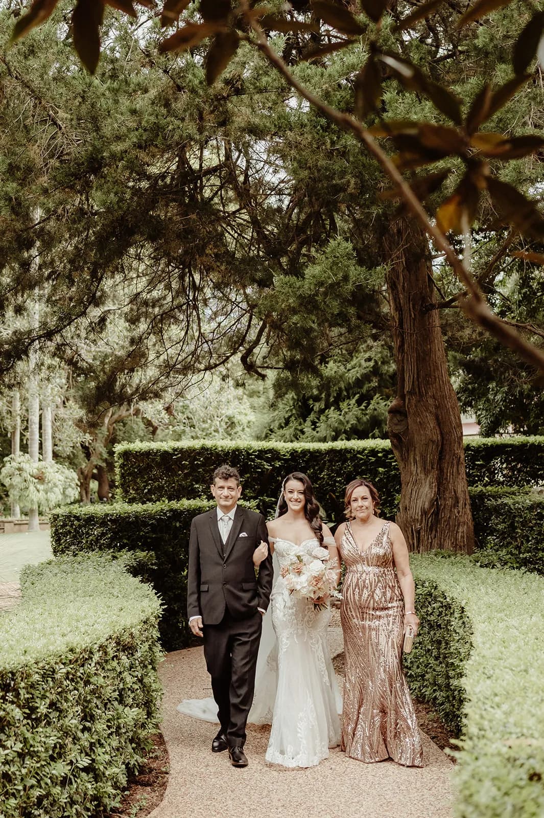 Bride walking down the aisle with parents