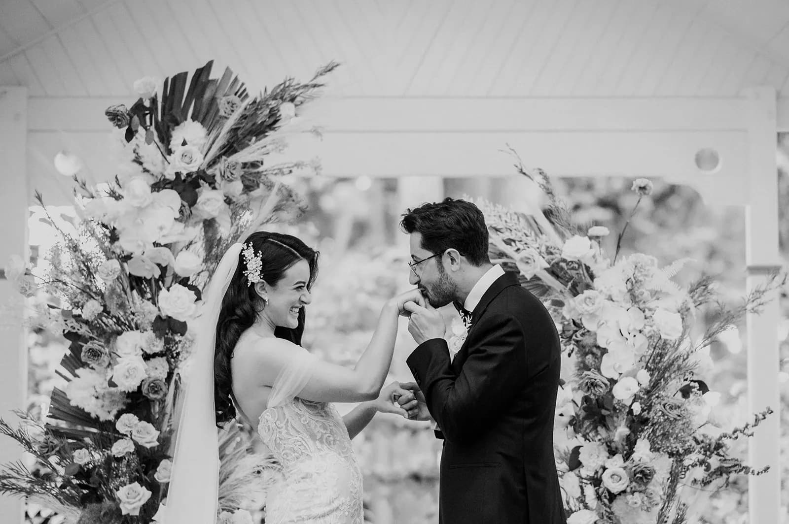 Groom kissing brides hand