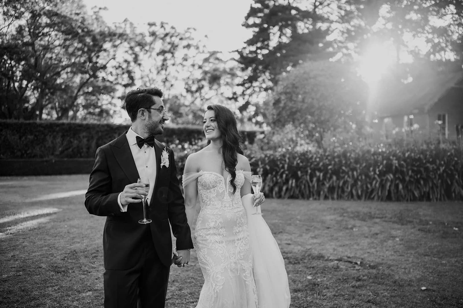 Bride and groom walking through gardens