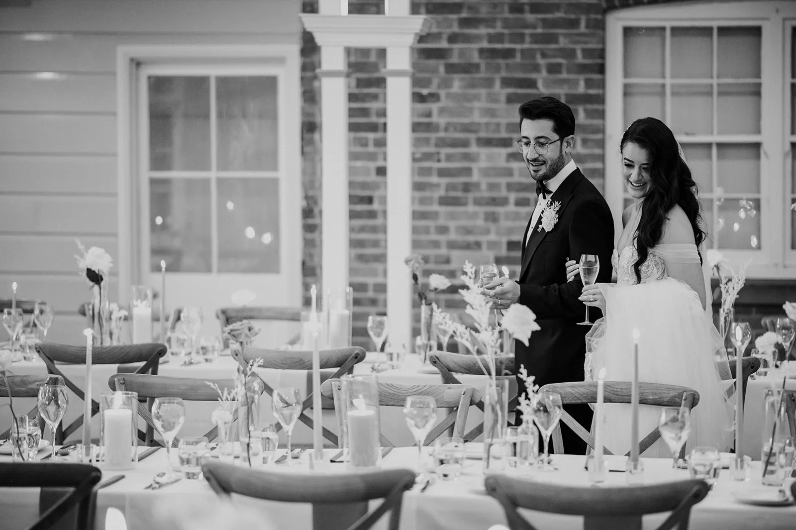 Bride and groom walking through wedding reception