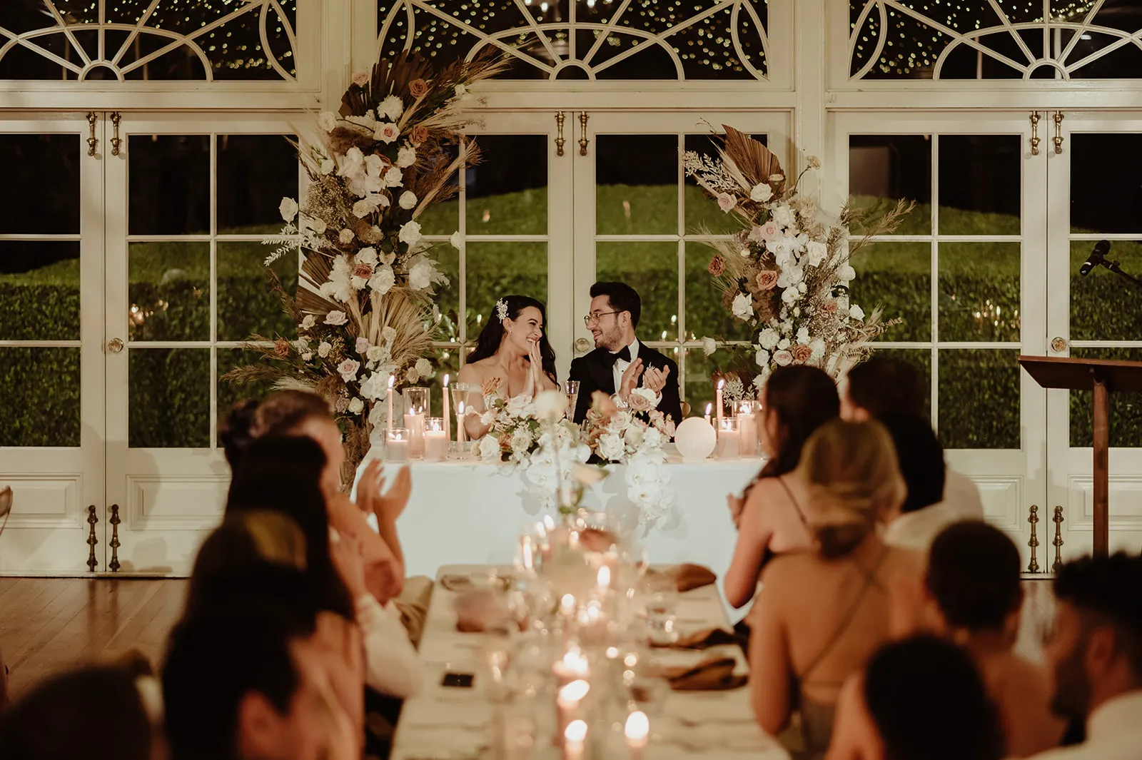 Bride and groom clapping during wedding reception