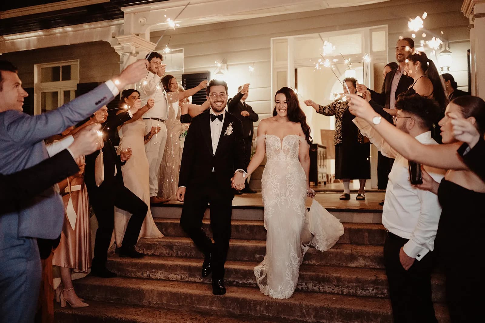 Bride and groom walking down stairs for sparkler exit