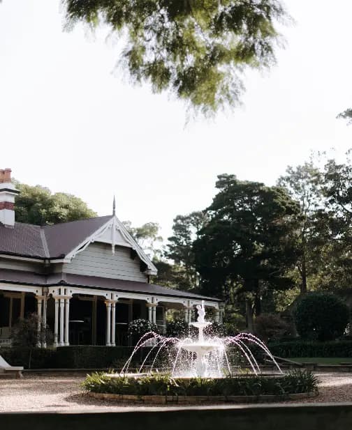 a pretty view of the water fountain at the front of the gabbinbar wedding venue