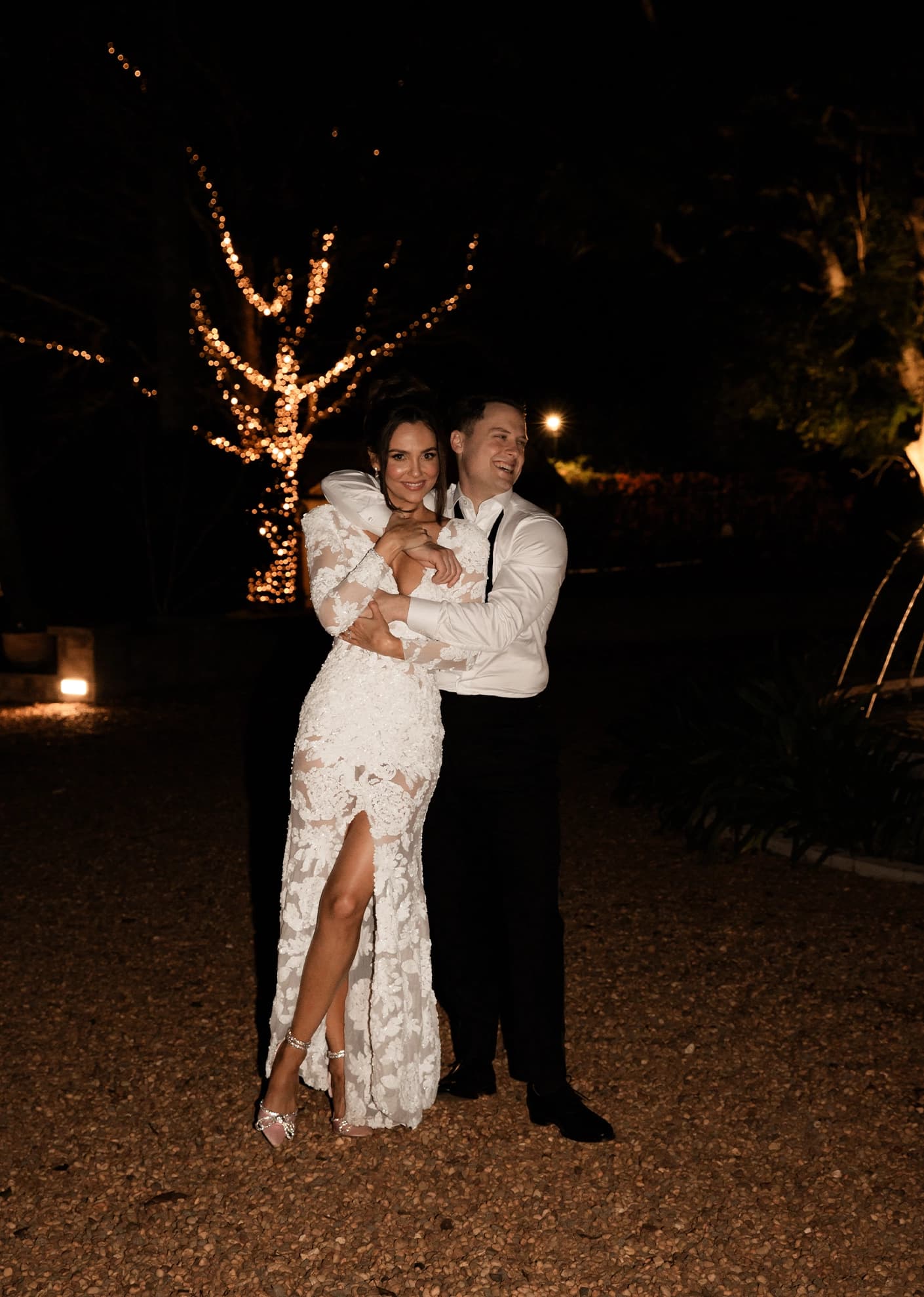 Couple embrace in the nigh garden