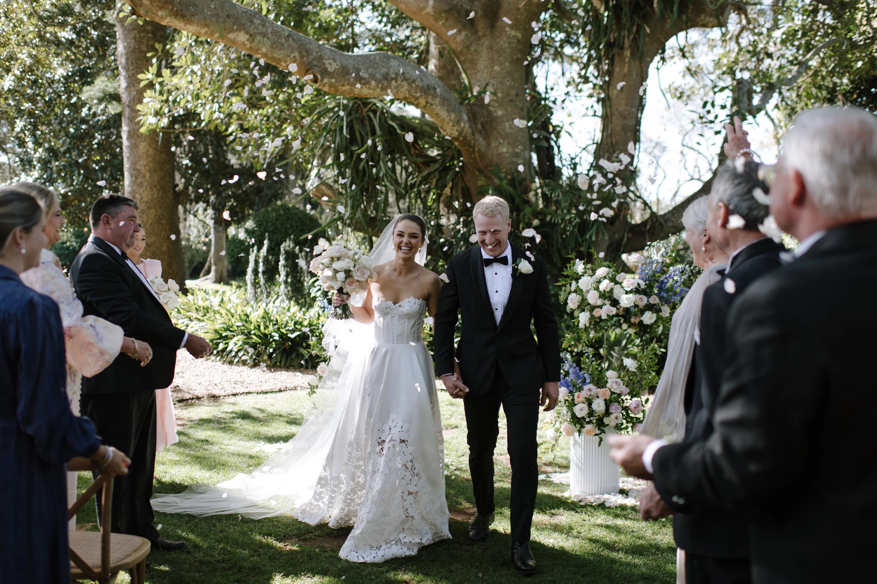 Couple celebrate post ceremony under a moreton bay fig tree