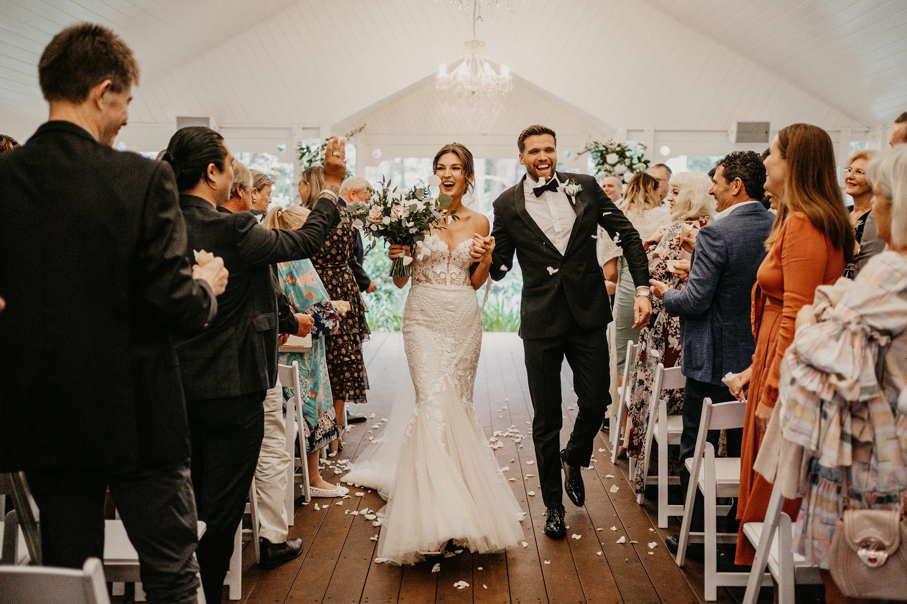 newlyweds walking down the aisle together celebrating their nuptials at gabbinbar wedding venue