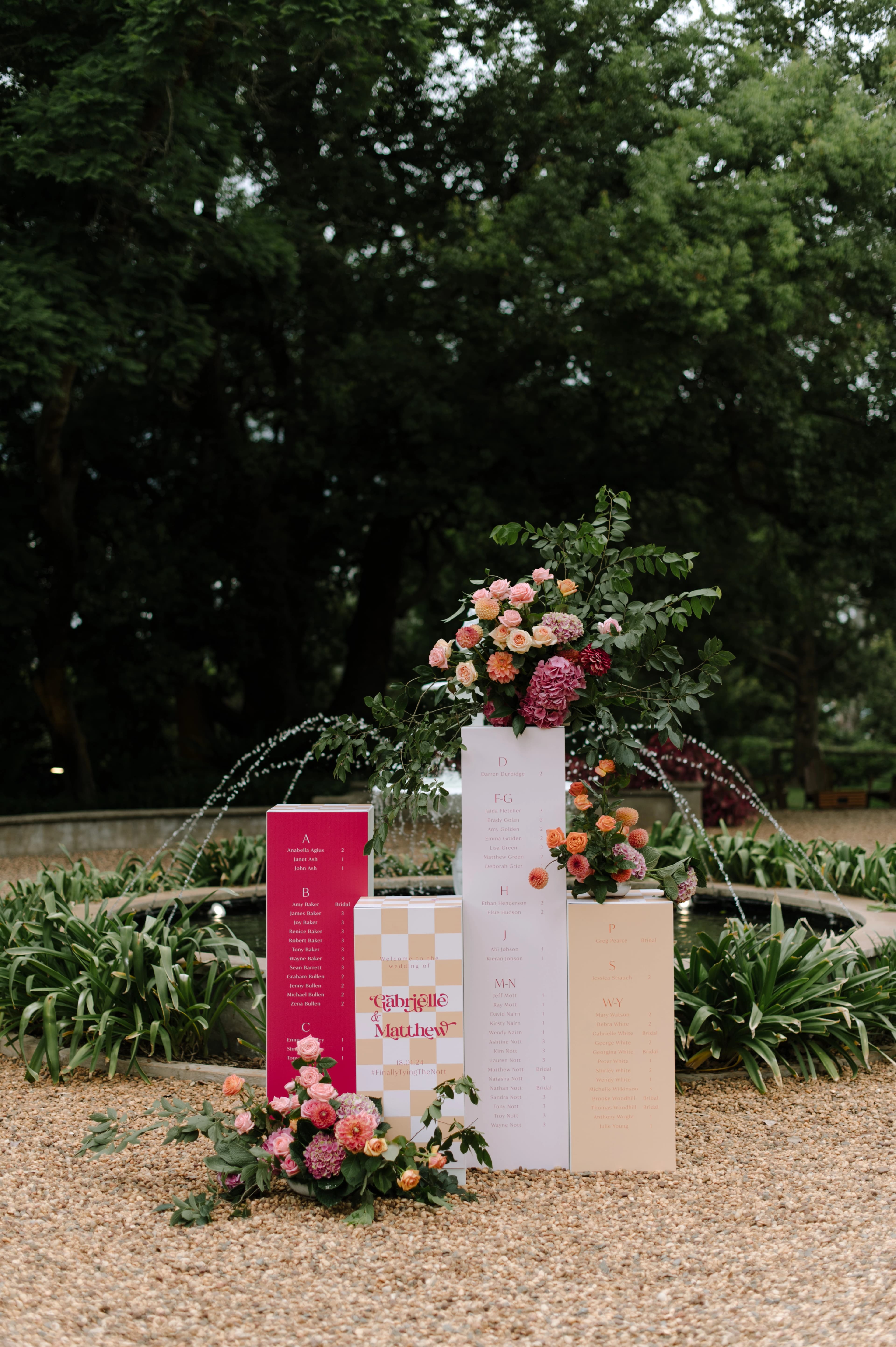 wedding table adorned with vibrant pink and orange flowers, creating a festive and romantic atmosphere.