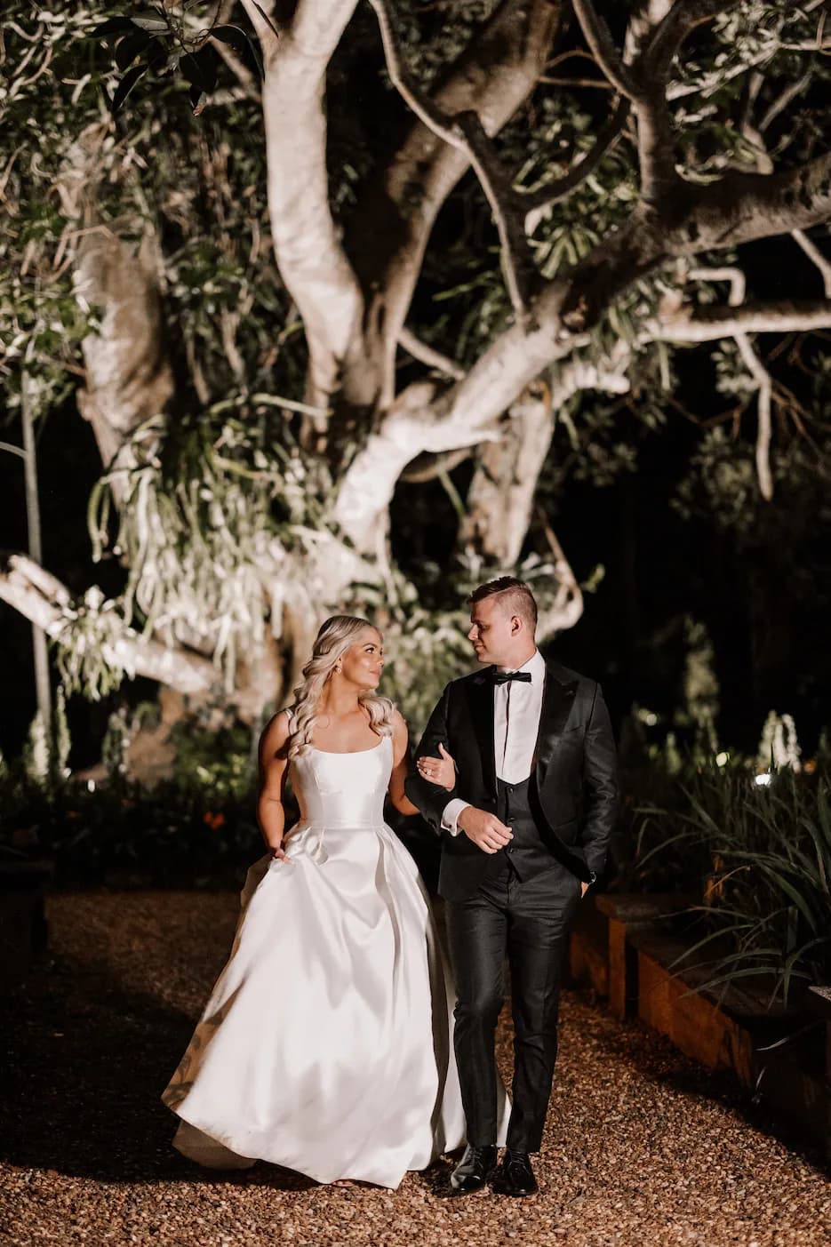 Bride and groom walking holding hands