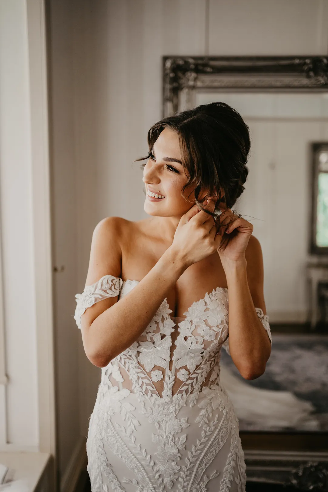 Bride puting her earrings in